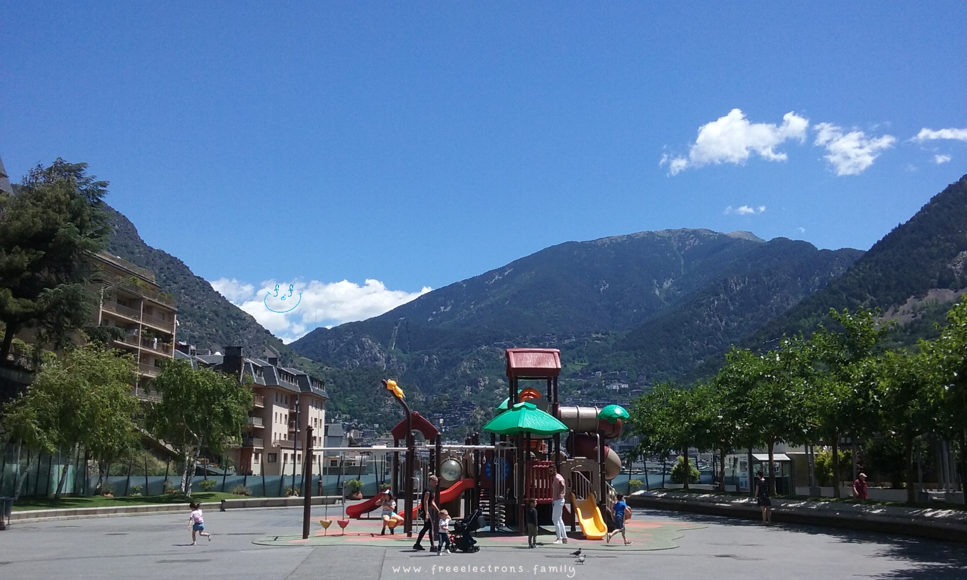 #FreeElectrons.Family - camping road trip Europe, Andorra town square.

The other playground on Plaça del Poble (town square) in Andorra-la-Vella where kids can play in relatively safety of the enclosed playground.  Keep an eye out though!