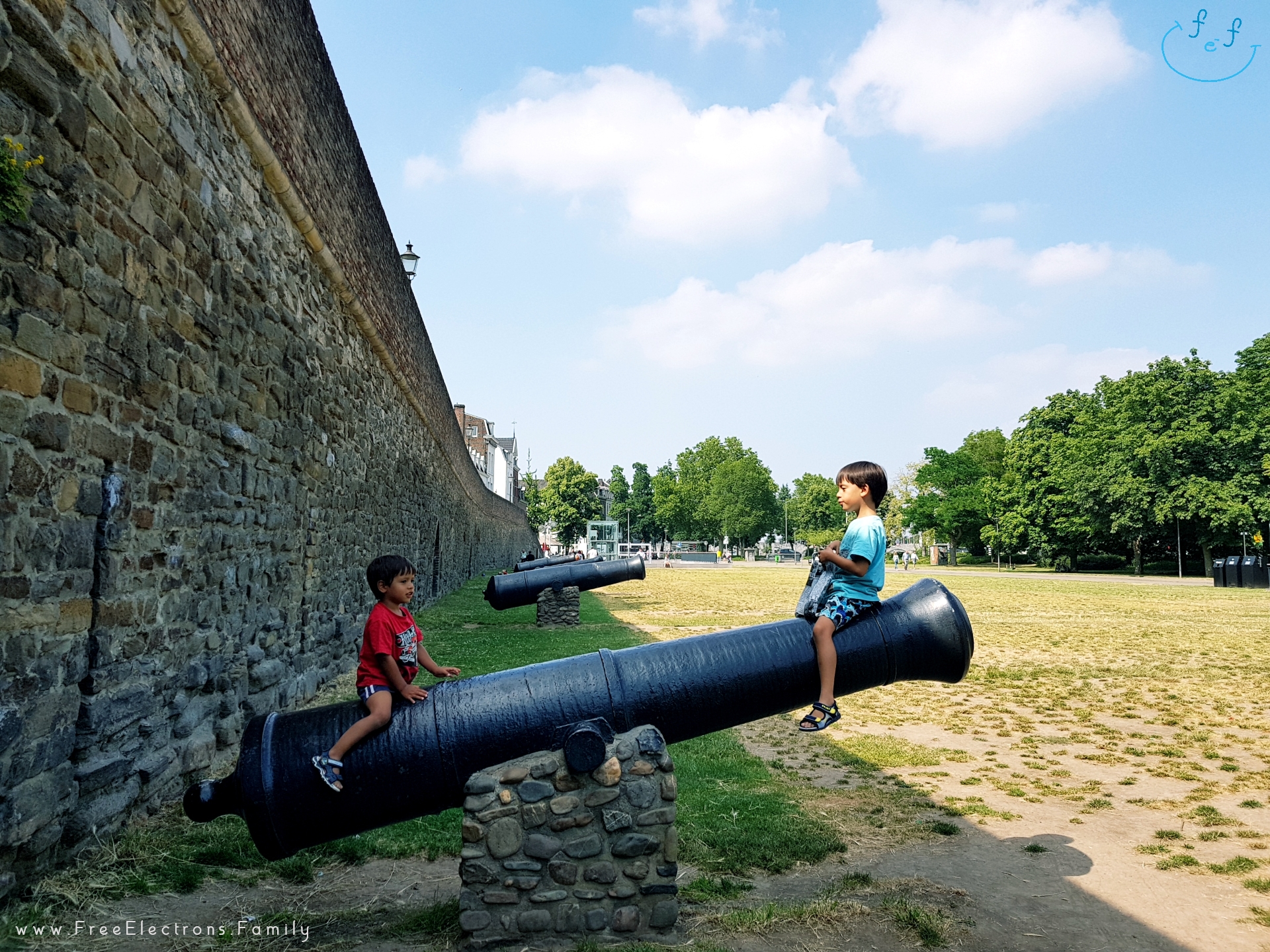 Canons surrounding the defensive walls around the old city of Maastricht within the gate of hell (Helport).  

Two young kids playfully riding on one.

#FreeElectrons.Family - camping road trip Europe Maastricht