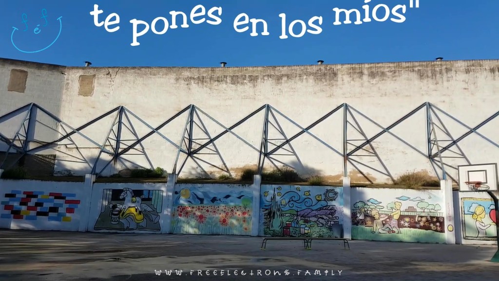 An outdoor patio with various paintings on the walls.  Text reads in Spanish, "te pones en los mios" you put yourself in mine).  
www.FreeElectrons.Family