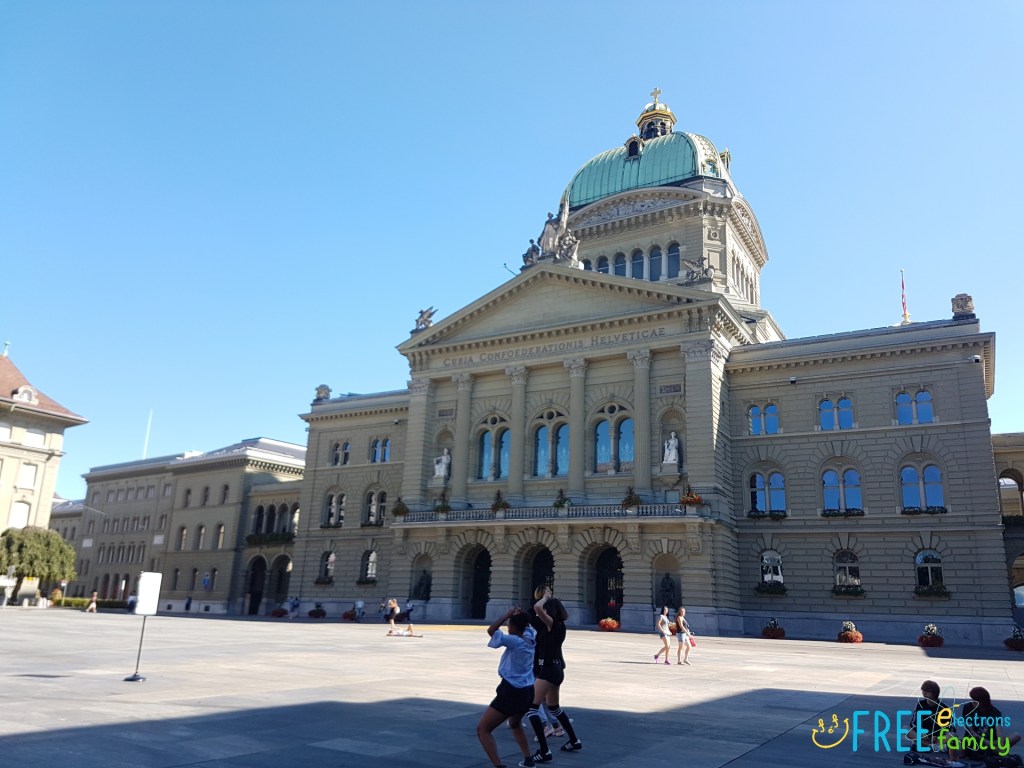 Bern Parliament Building and Bundesplatz (Parliament Square)  with teenagers dancing in the foreground.
www.FreeElectrons.Family 