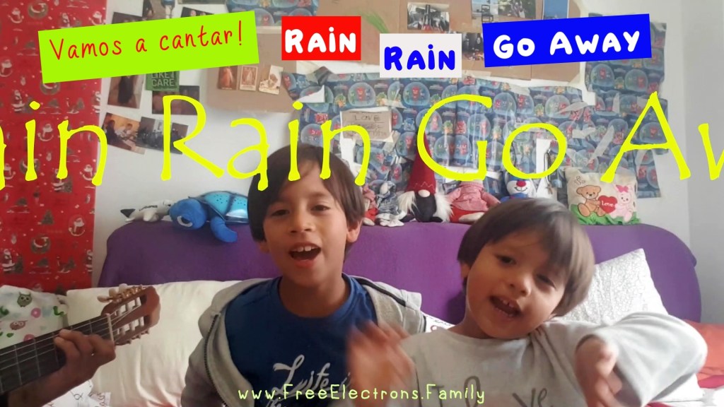 Two young kids singing in bedroom to a father's acoustic guitar playing.  Text in picture reads: Vamos a cantar! Rain Rain Go Away.