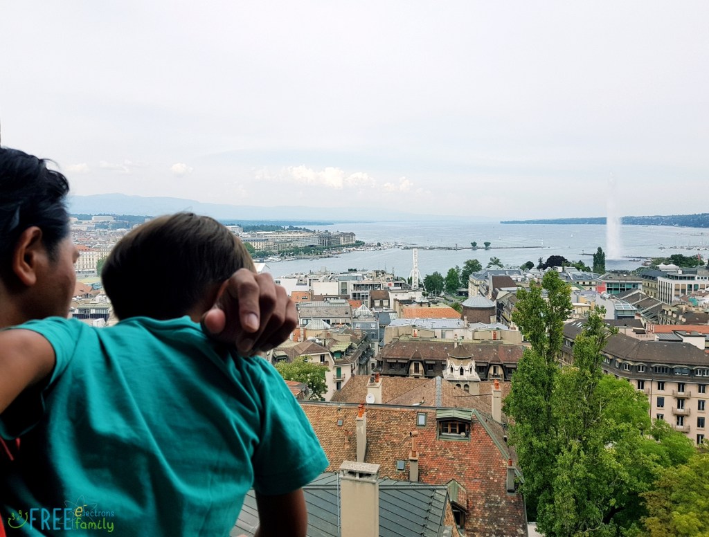 A father carrying son, both looking at Geneva's lakeshore from the high viewpoint of a Cathedral tower. 

www.FreeElectrons.Family