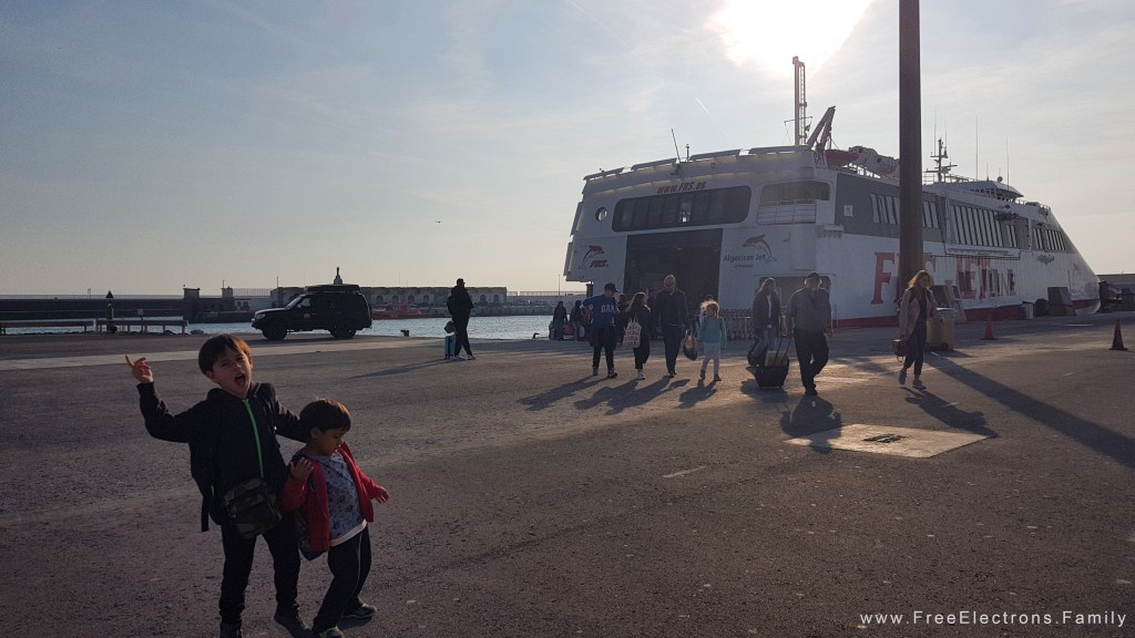 Happy young boys and other passengers after disembarking from a ferry.