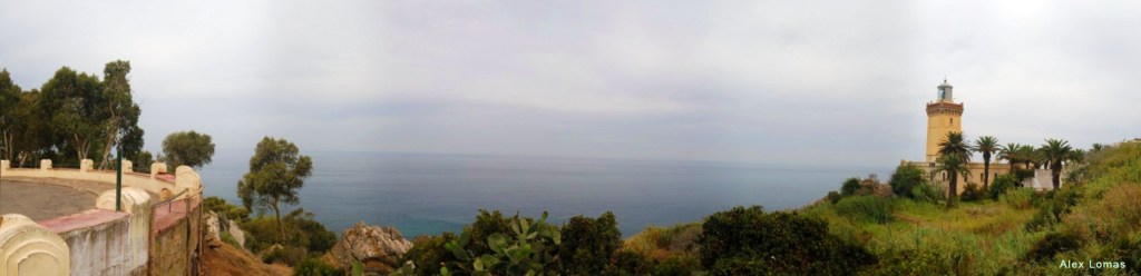Panoramic view of a lighthouse and a terrace overlooking the ocean.